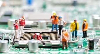 Engineers working over a circuit assembly